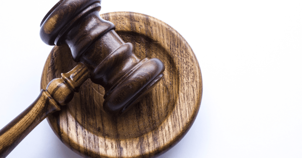 a wooden gavel on a wooden coaster