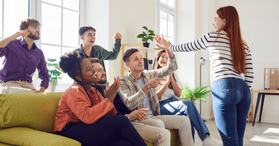 A girl giving a high five to a group. how to develop social skills in teens