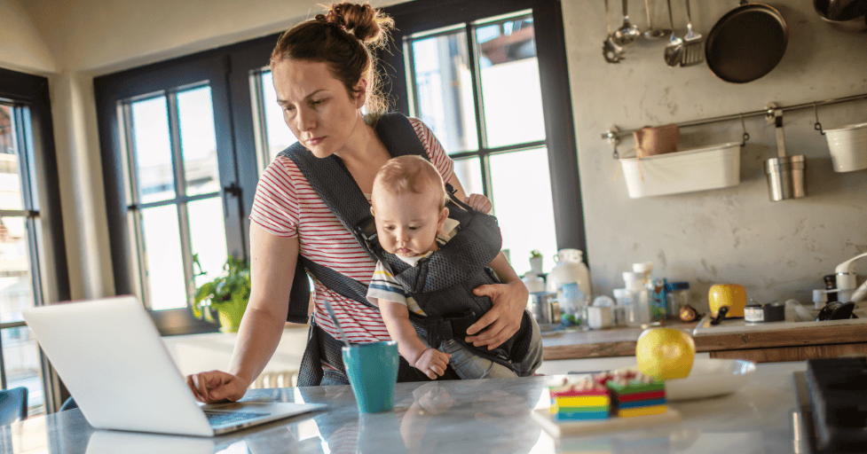 how to create a goal chart for kids mom looking at a laptop holding a baby
