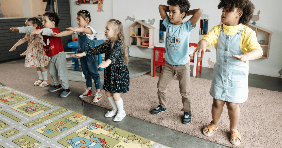 morning routine kindergarten young children in a classroom doing exercises