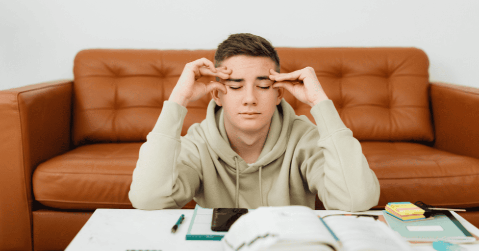 ADHD homework tips young man stressed at table