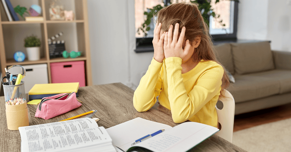 ADHD child struggling with homework focus ADHD homework tips girl stressed at table